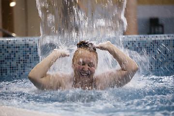 Image showing Woman playing under a water fountain