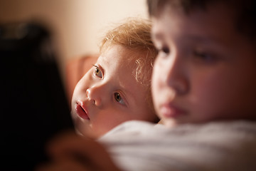 Image showing Cute young child relaxing with his brother