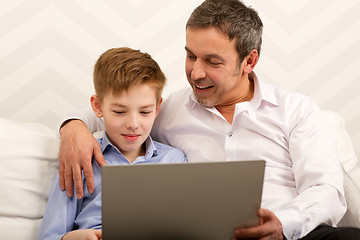 Image showing Boy and father using laptop together