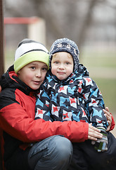 Image showing Two adorable young brothers outdoors in winter