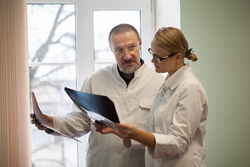 Image showing Two doctors analyzing x-ray images