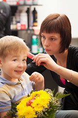 Image showing Young boy getting haircut from styist