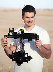 Image showing Smiling man with steadicam equipment outdoor