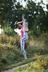 Image showing Athletic young woman working out in the country