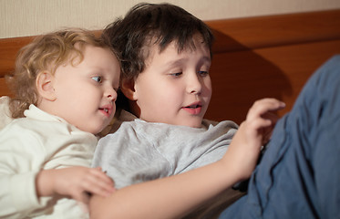 Image showing Two young children playing with a tablet