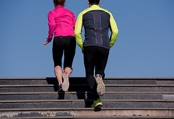 Image showing young  couple jogging on steps