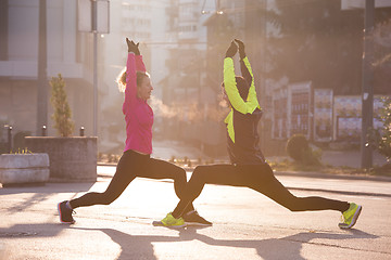 Image showing couple warming up before jogging