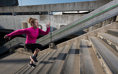 Image showing woman jogging on  steps