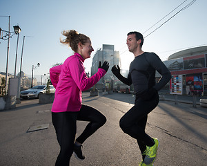 Image showing couple warming up before jogging