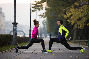 Image showing couple warming up before jogging