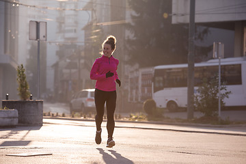 Image showing sporty woman jogging on morning