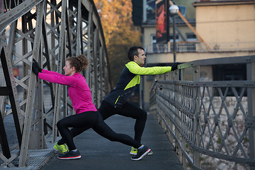 Image showing couple warming up before jogging