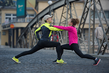 Image showing couple warming up before jogging