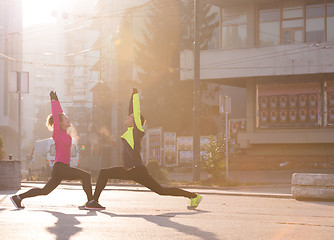 Image showing couple warming up before jogging