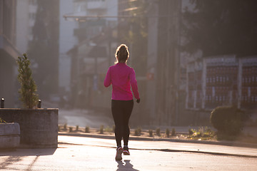 Image showing sporty woman jogging on morning