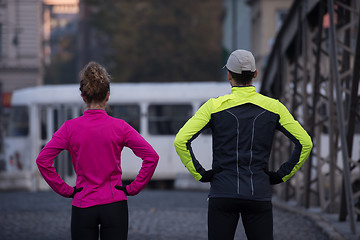 Image showing couple warming up before jogging