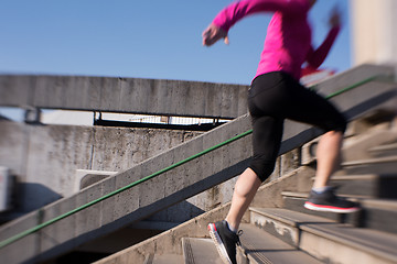 Image showing woman jogging on  steps