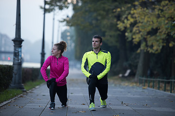 Image showing couple warming up before jogging