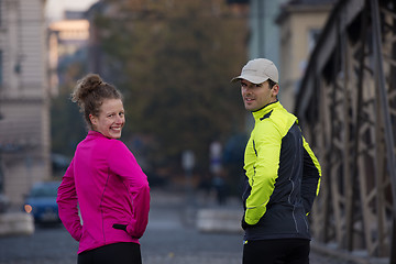 Image showing couple warming up before jogging