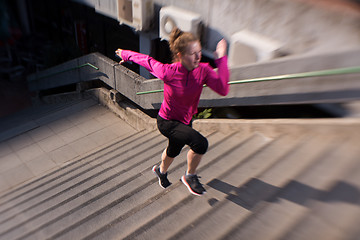 Image showing woman jogging on  steps