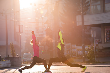 Image showing couple warming up before jogging