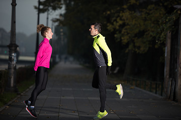 Image showing couple warming up before jogging