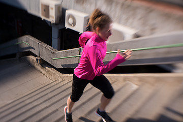 Image showing woman jogging on  steps