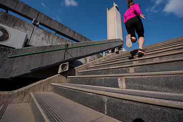 Image showing woman jogging on  steps