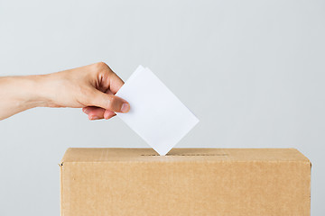 Image showing man putting his vote into ballot box on election