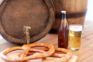 Image showing close up of beer barrel, glass, pretzel and bottle