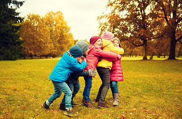 Image showing group of happy children hugging in autumn park