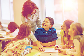 Image showing group of school kids writing test in classroom