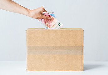 Image showing man putting euro money into donation box