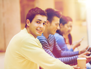 Image showing group of students with tablet pc and coffee cup