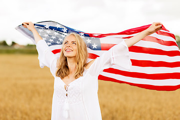 Image showing happy woman with american flag on cereal field