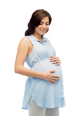 Image showing happy pregnant woman touching her big belly