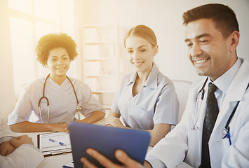 Image showing happy doctors with tablet pc meeting at hospital