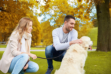 Image showing happy couple with labrador dog walking in city