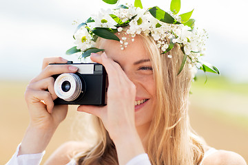 Image showing happy woman with film camera in wreath of flowers