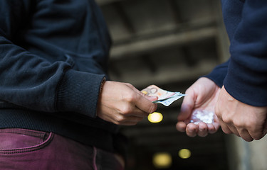 Image showing close up of addict buying dose from drug dealer