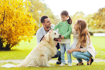 Image showing happy family with labrador retriever dog in park