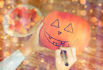 Image showing close up of woman with pumpkins at home