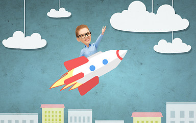 Image showing businesswoman flying on rocket above cartoon city