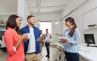 Image showing creative team with tablet pc and papers at office