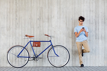 Image showing man with smartphone and fixed gear bike on street