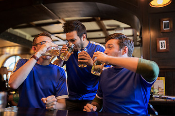 Image showing football fans or friends drink beer at sport bar