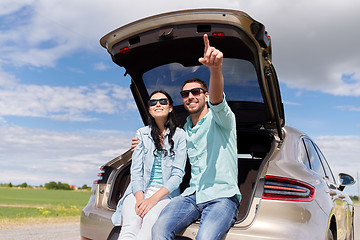 Image showing happy couple hugging at open hatchback car trunk