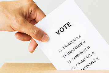 Image showing man putting his vote into ballot box on election