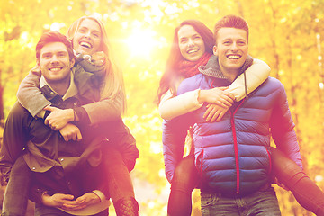 Image showing smiling friends having fun in autumn park