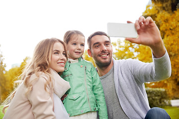 Image showing happy family taking selfie by smartphone outdoors